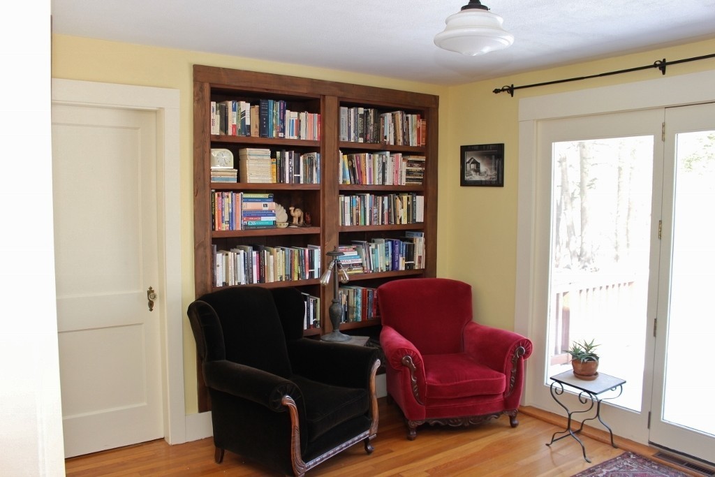98 Old Ferry Road Haverhill, MA 01830 - Photo 5 of 14 a view of a workspace with furniture and a book shelf