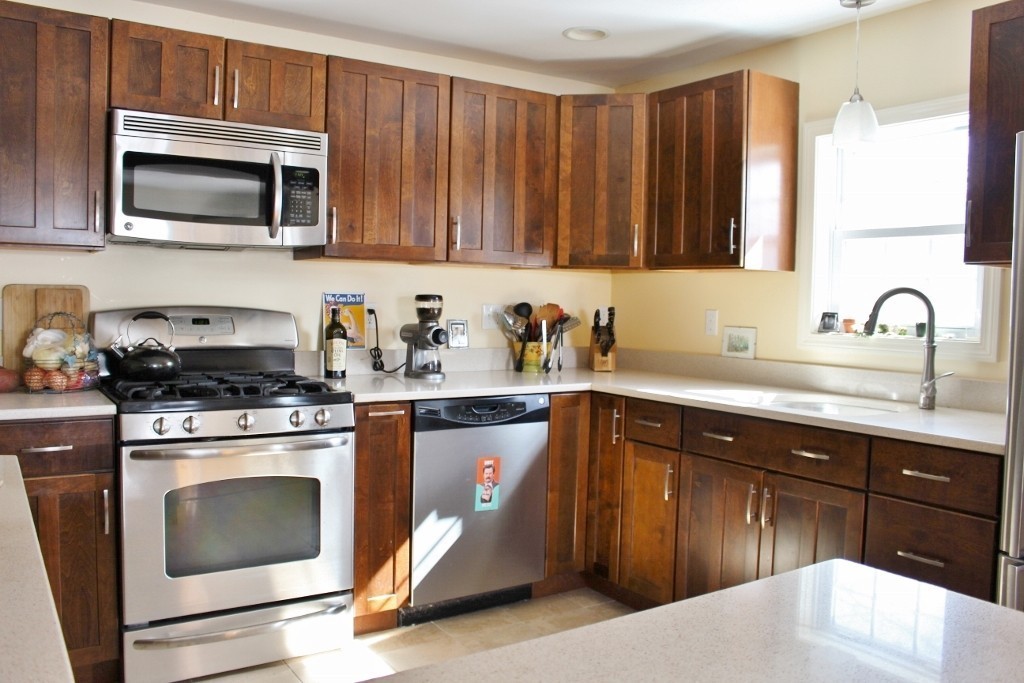 98 Old Ferry Road Haverhill, MA 01830 - Photo 9 of 14 a kitchen with a sink stove and microwave