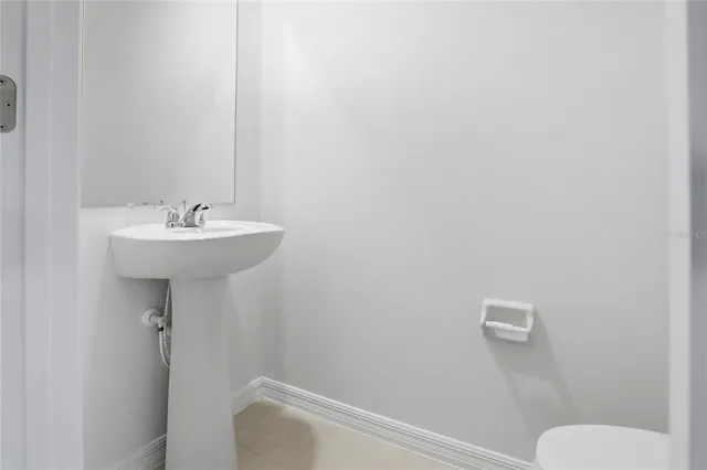 a bathroom with a sink mirror and toilet