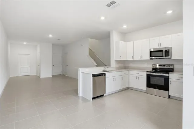 a kitchen with a sink stainless steel appliances and cabinets