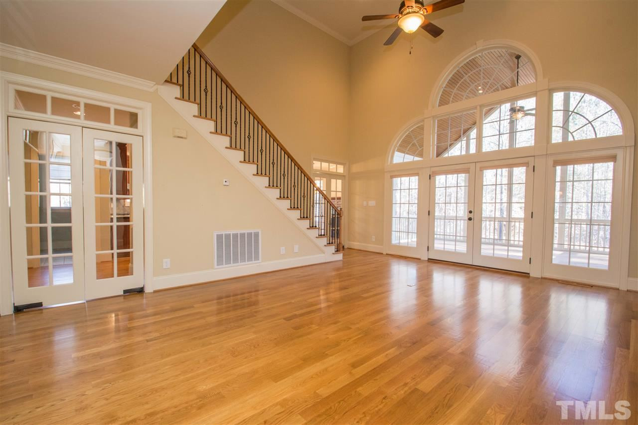 1068 Tacketts Pond Drive Raleigh, NC 27614 - Photo 7 of 25 Amazing two story family room with an amazing gas log fireplace and gorgeous built-ins. Enjoy all the space and wall of architectural windows with access to the screened porch Family Room