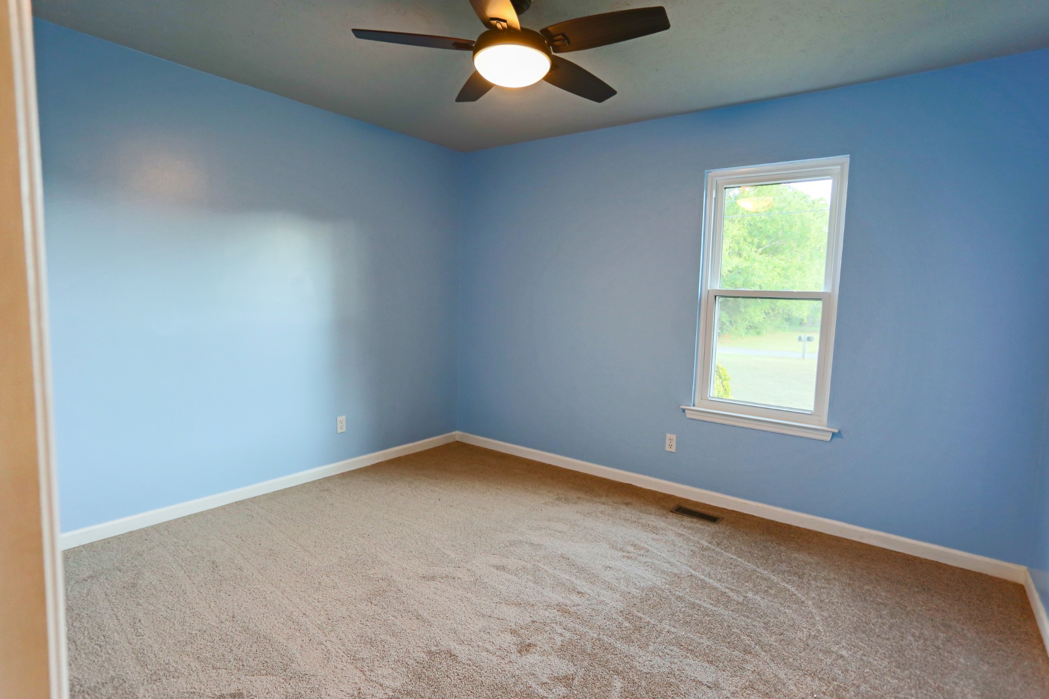 7460 Joe Rowlin Road Christiana, TN 37037 - Photo 12 of 26 an empty room with a window and a fan