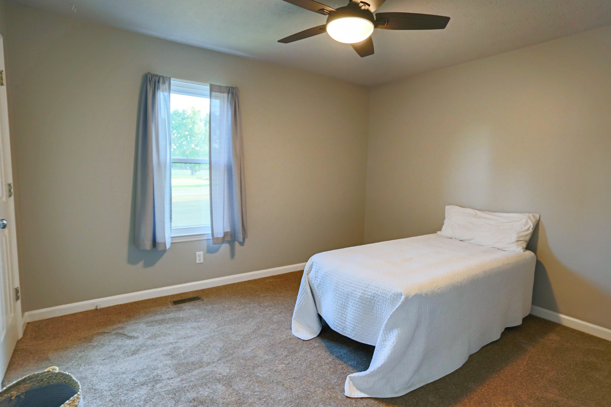 7460 Joe Rowlin Road Christiana, TN 37037 - Photo 15 of 26 a bed sitting in a bedroom next to a window