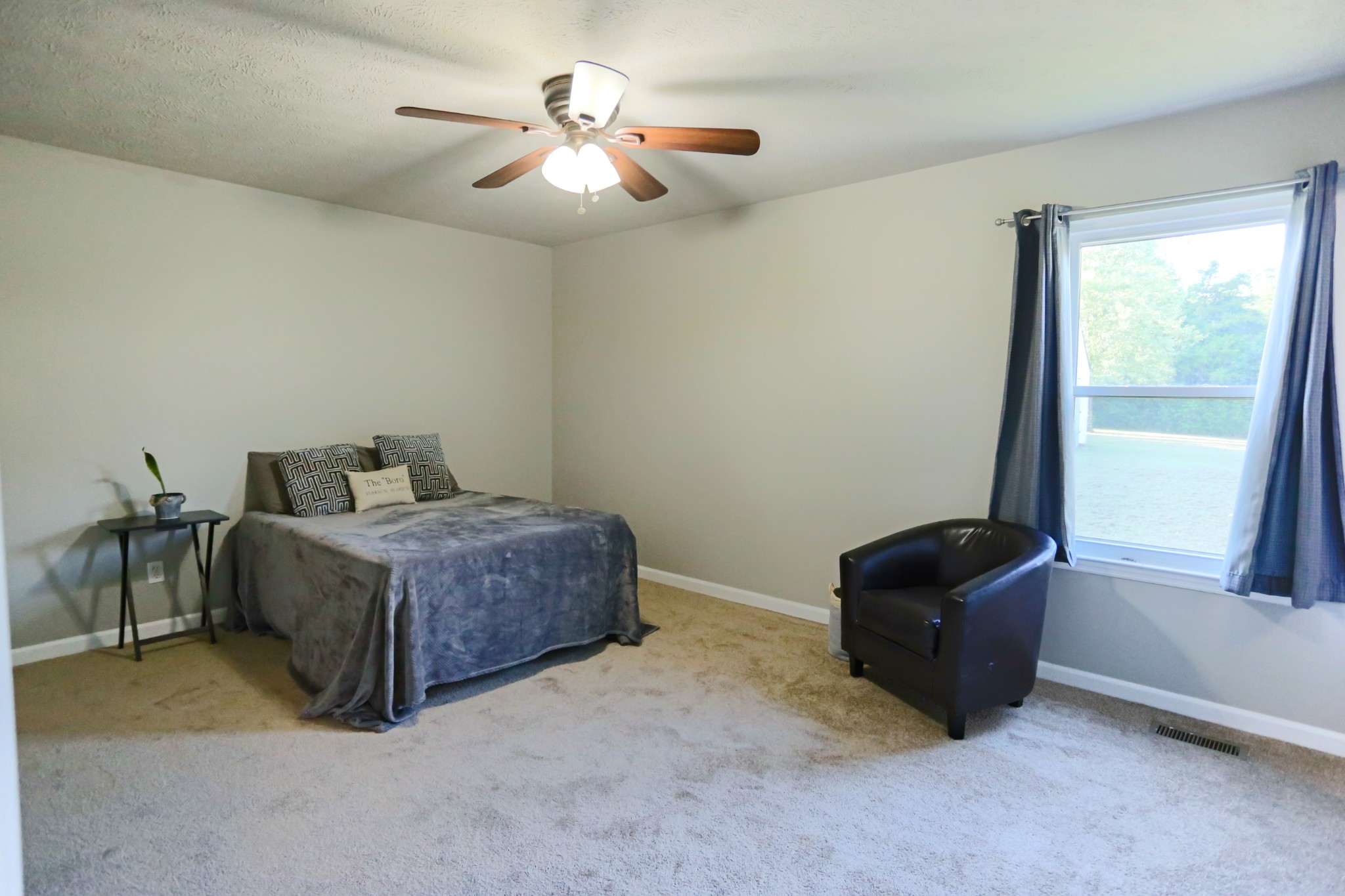 7460 Joe Rowlin Road Christiana, TN 37037 - Photo 17 of 26 a bedroom with a bed and a chandelier