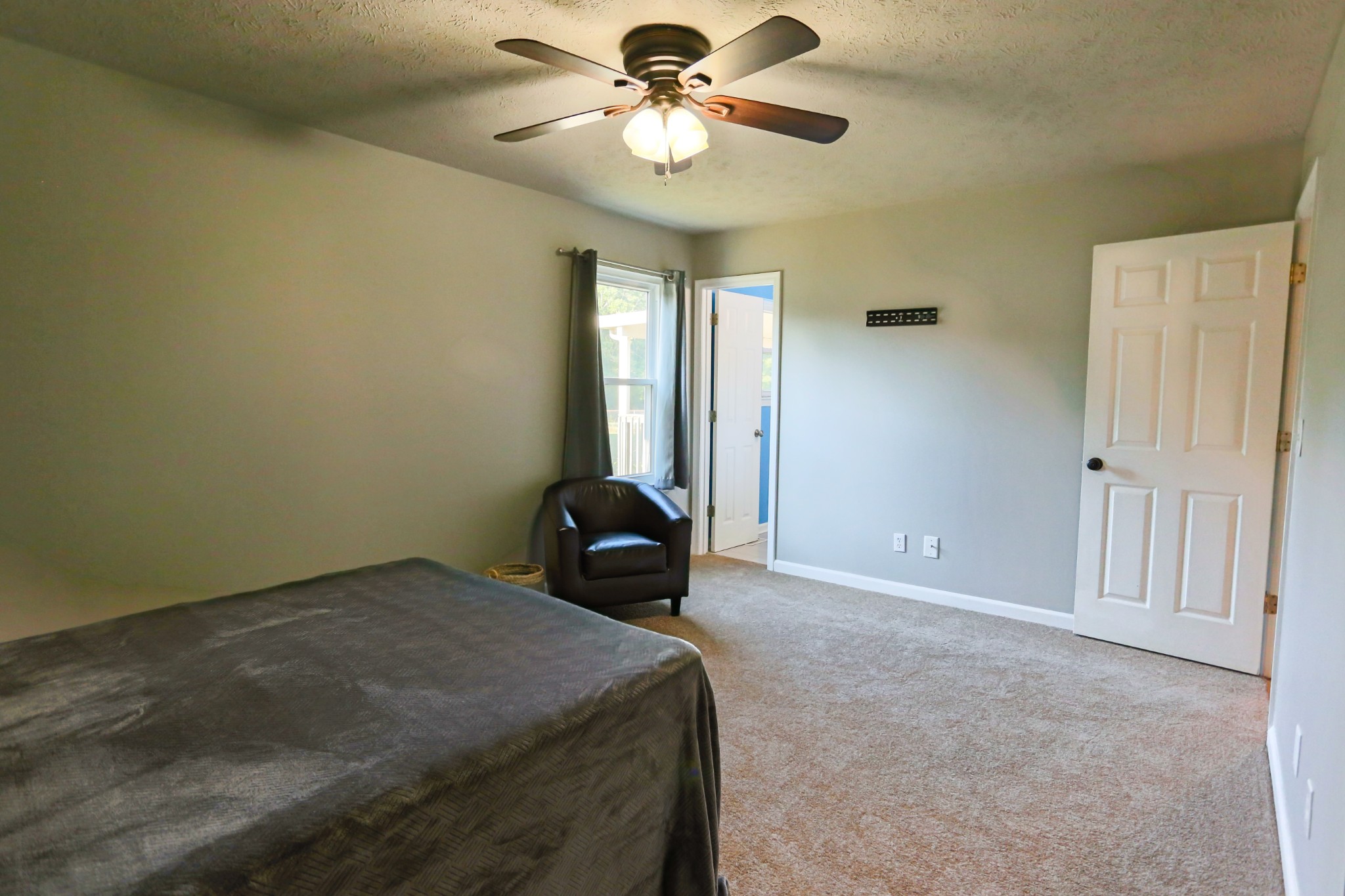 7460 Joe Rowlin Road Christiana, TN 37037 - Photo 19 of 26 a bedroom with a bed and a chandelier fan