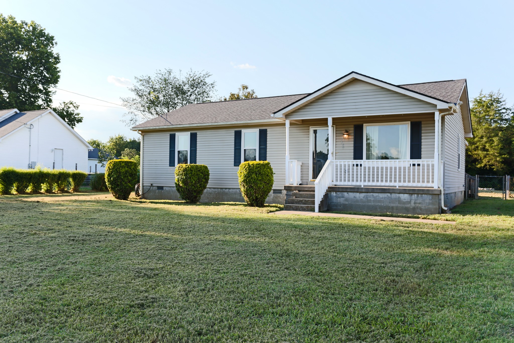 7460 Joe Rowlin Road Christiana, TN 37037 - Photo 4 of 26 a front view of a house with a yard and garage