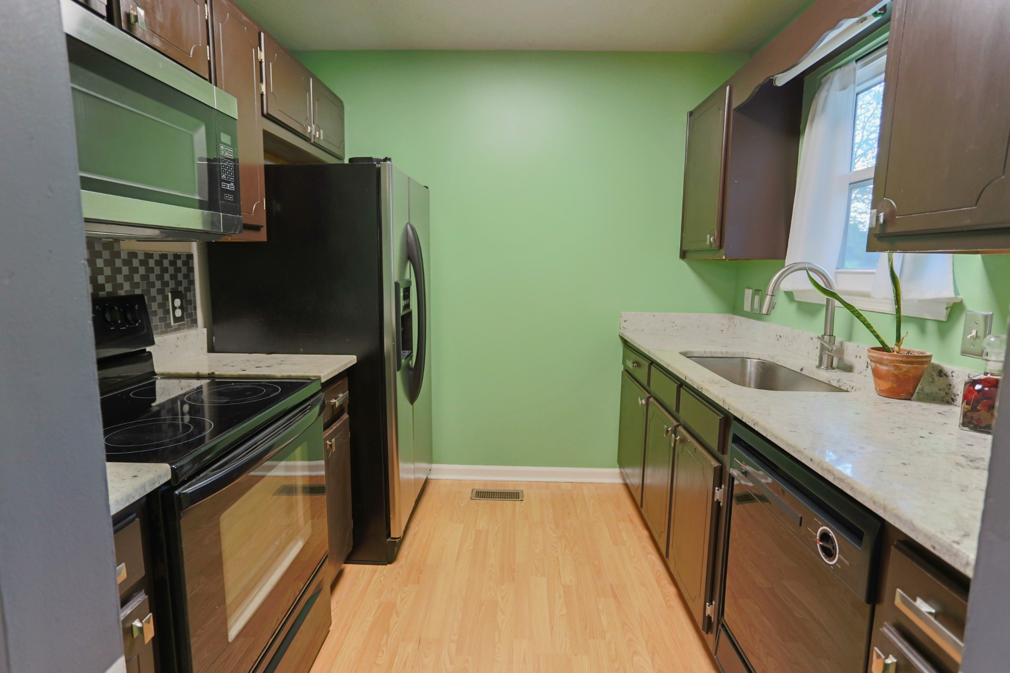 7460 Joe Rowlin Road Christiana, TN 37037 - Photo 10 of 26 a kitchen with granite countertop a sink stove and refrigerator