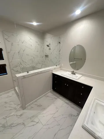 a spacious bathroom with a double vanity sink a mirror and a bathtub