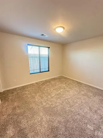 an empty room with a empty space and windows