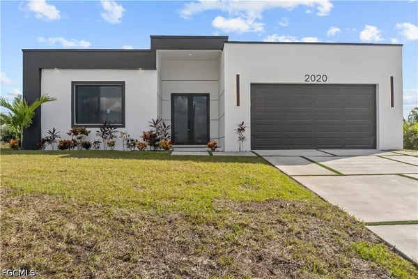 a view of yellow house with outdoor seating