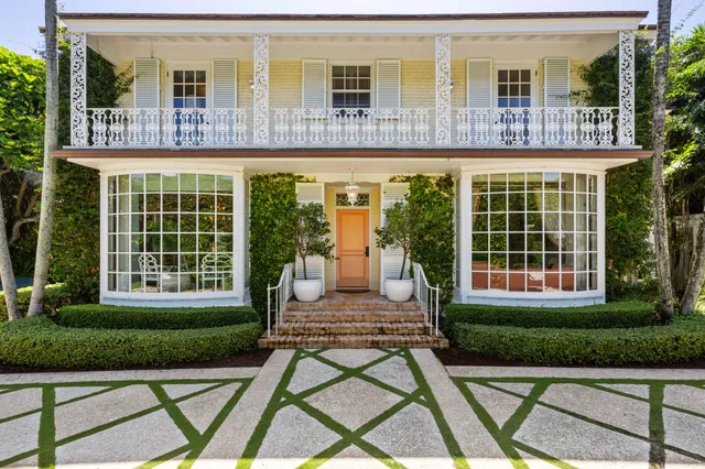 a front view of a house with a yard table and chairs