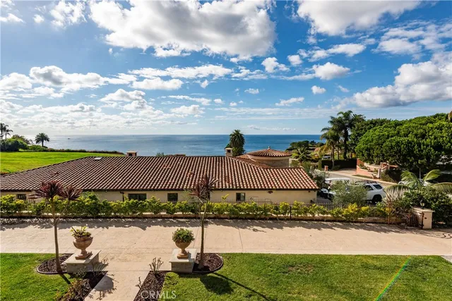 a bathroom with a granite countertop double vanity sink and a mirror