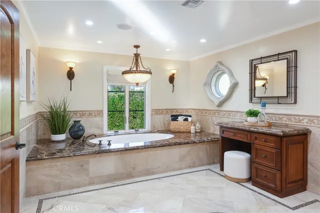 a large living room with stainless steel appliances granite countertop a couch a dining table and chairs