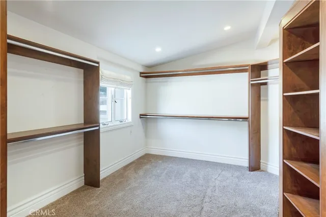 a large bedroom with bed and glass door