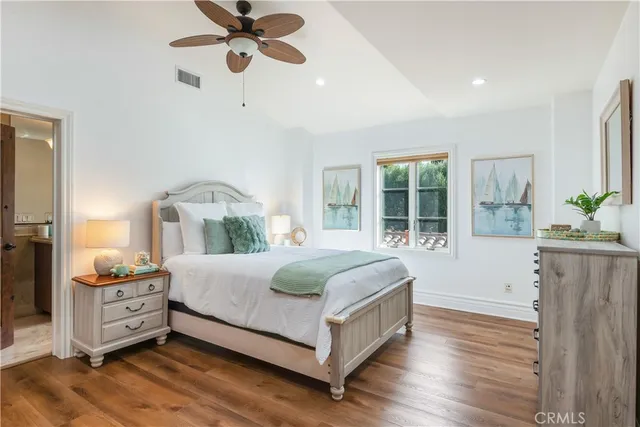 a spacious bedroom with a bed and a window