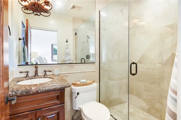 a bathroom with a granite countertop sink mirror and vanity