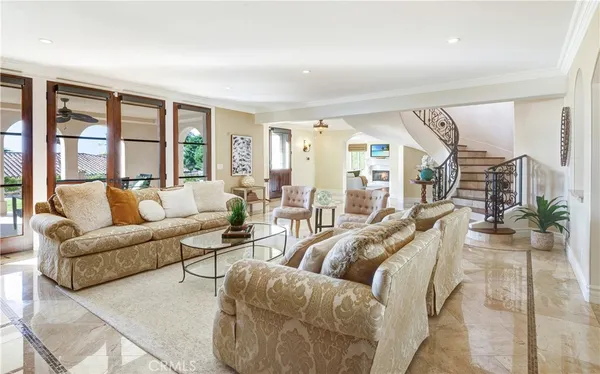 a living room with furniture and floor to ceiling windows
