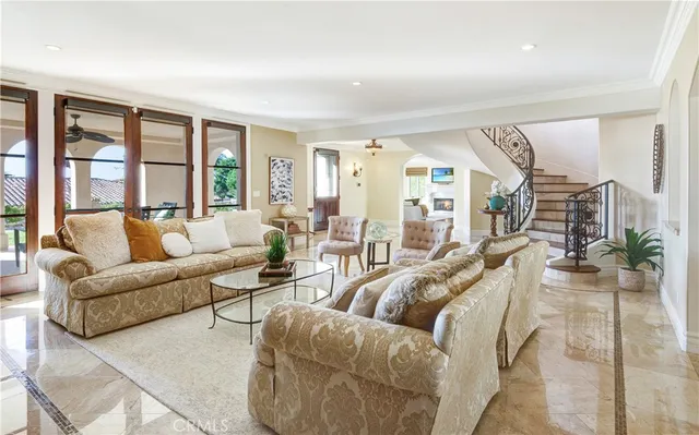 a living room with furniture and floor to ceiling windows