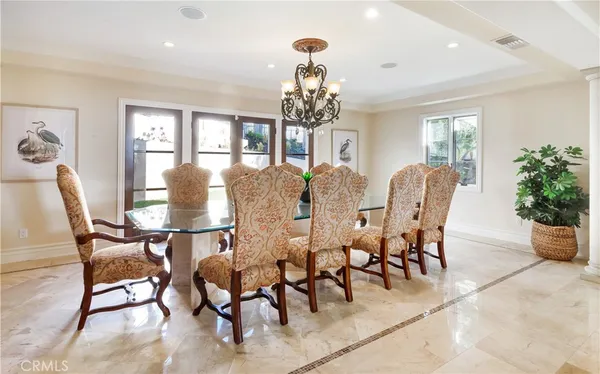 a view of a dining room with furniture and chandelier