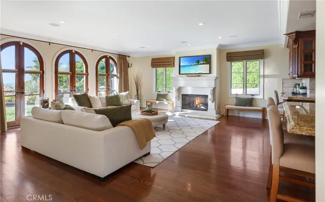 a living room with fireplace furniture and a large window