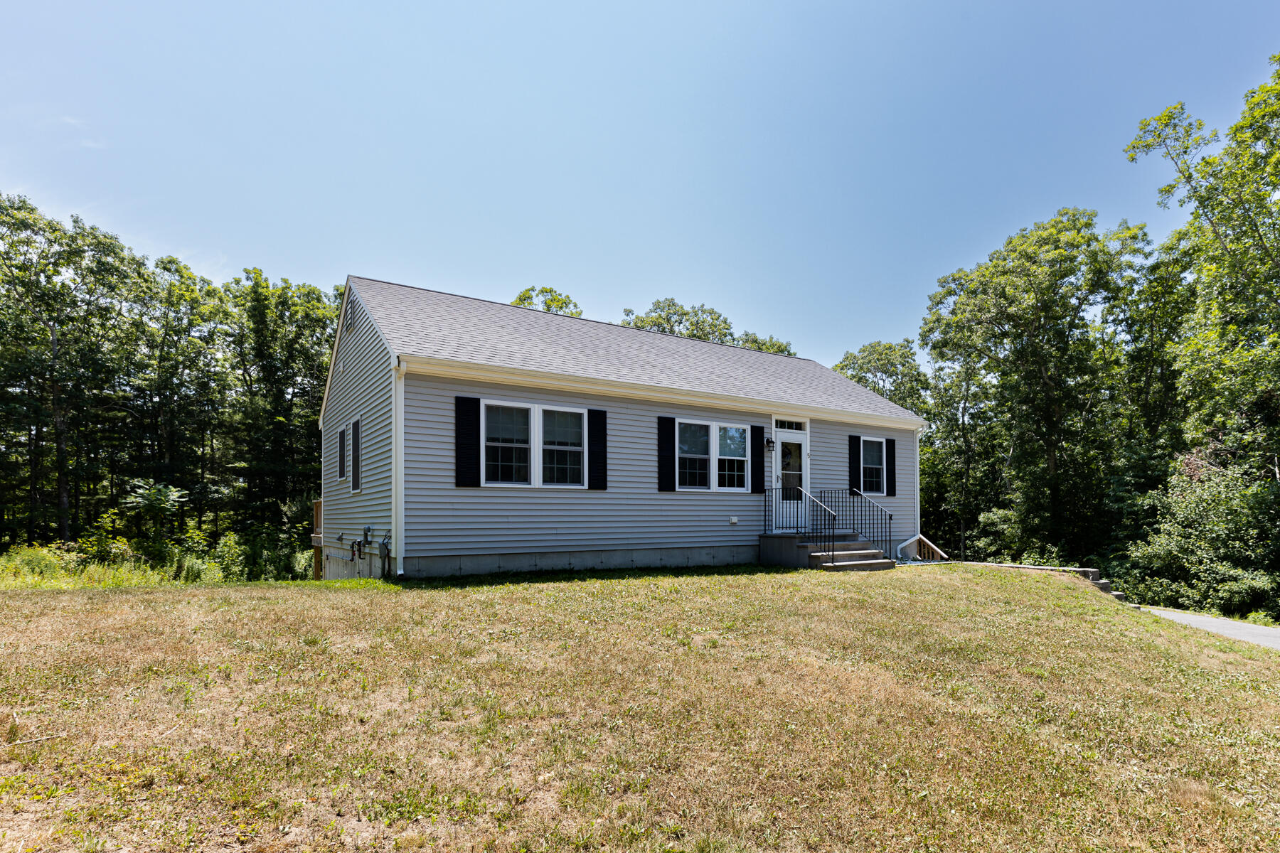 5 Whiffletree Circle Sandwich, MA 02563 - Photo 27 of 33 a front view of house with yard and trees in the background
