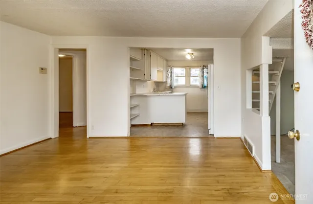 a view of a kitchen with a sink and a refrigerator