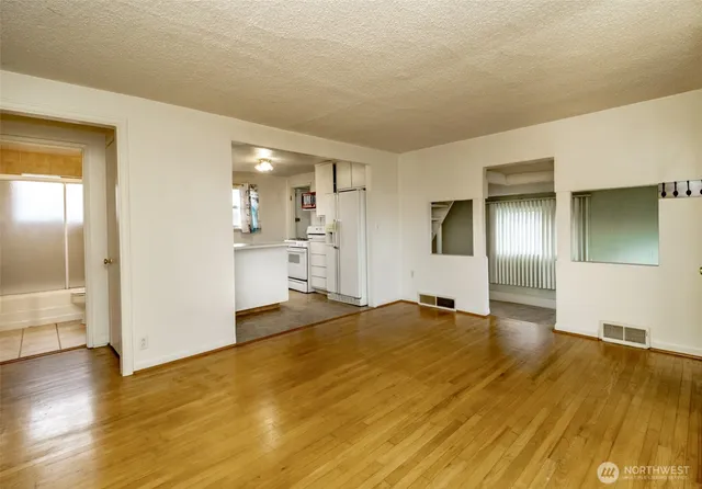 a view of empty room with wooden floor