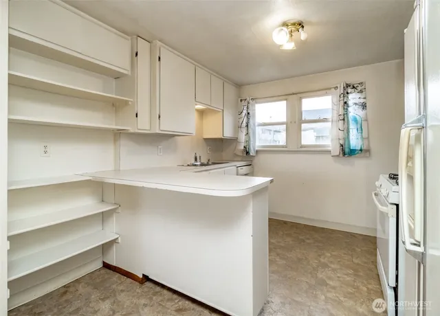 a kitchen with a sink cabinets and window