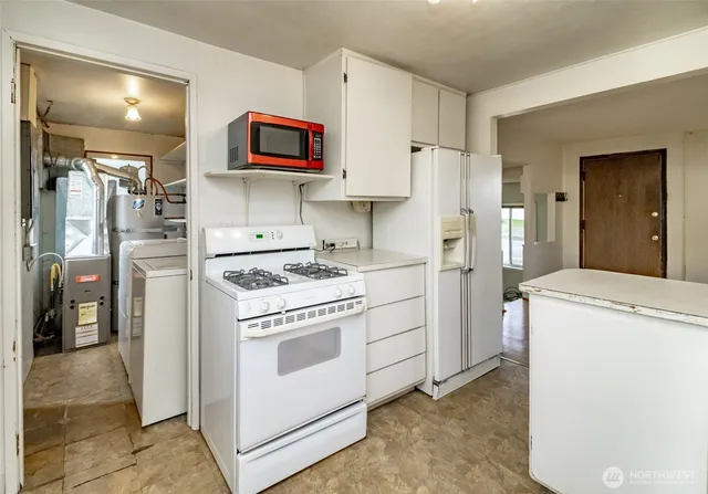 a kitchen with a stove and a refrigerator