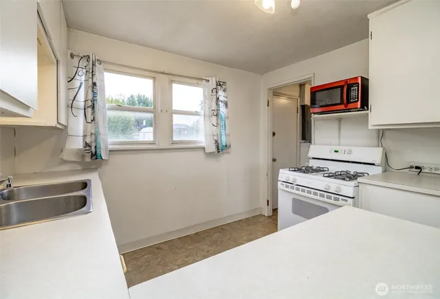 a kitchen with stainless steel appliances a stove a sink and a refrigerator