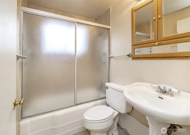 a bathroom with a toilet a sink and a shower