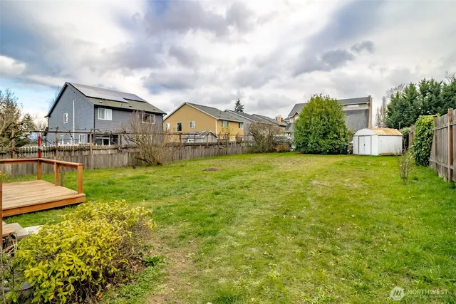 a view of a house with a big yard and potted plants