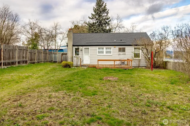 a view of a house with a yard and sitting area