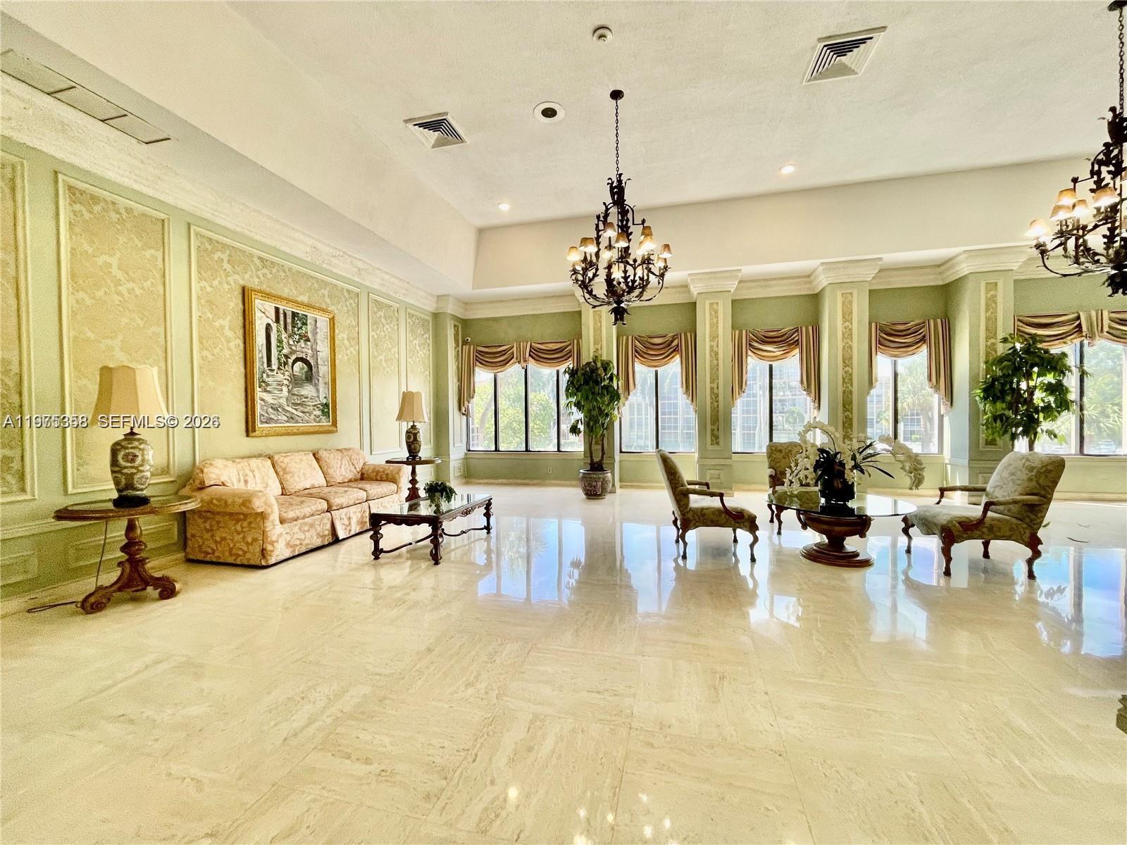 600 Three Islands Boulevard, Unit 1014 Hallandale Beach, FL 33009 - Photo 11 of 13 a living room with furniture and a chandelier