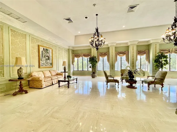 a living room with furniture and a chandelier