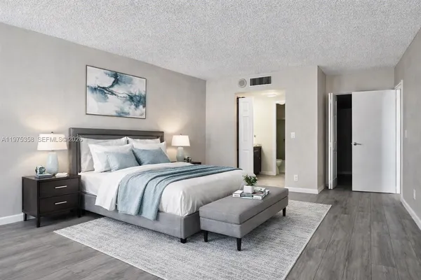 a bedroom with bed and a couch