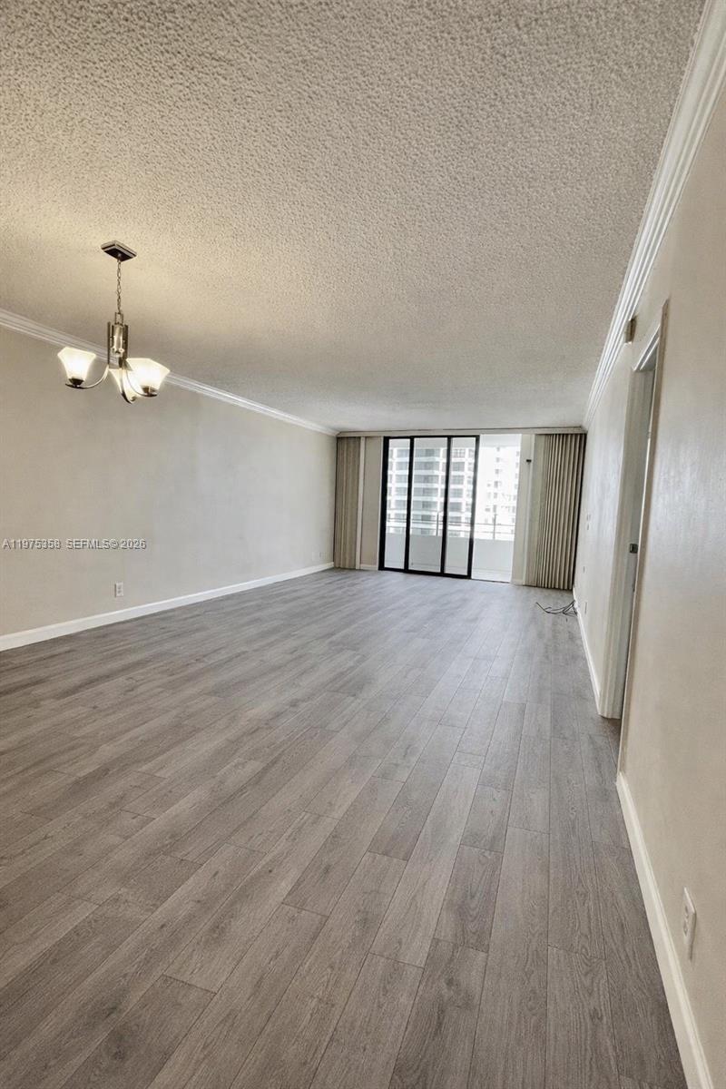 600 Three Islands Boulevard, Unit 1014 Hallandale Beach, FL 33009 - Photo 8 of 13 wooden floor in an empty room with a window