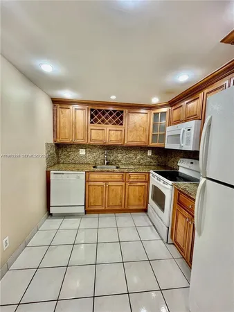 a kitchen with stainless steel appliances granite countertop a stove a sink and a counter top space
