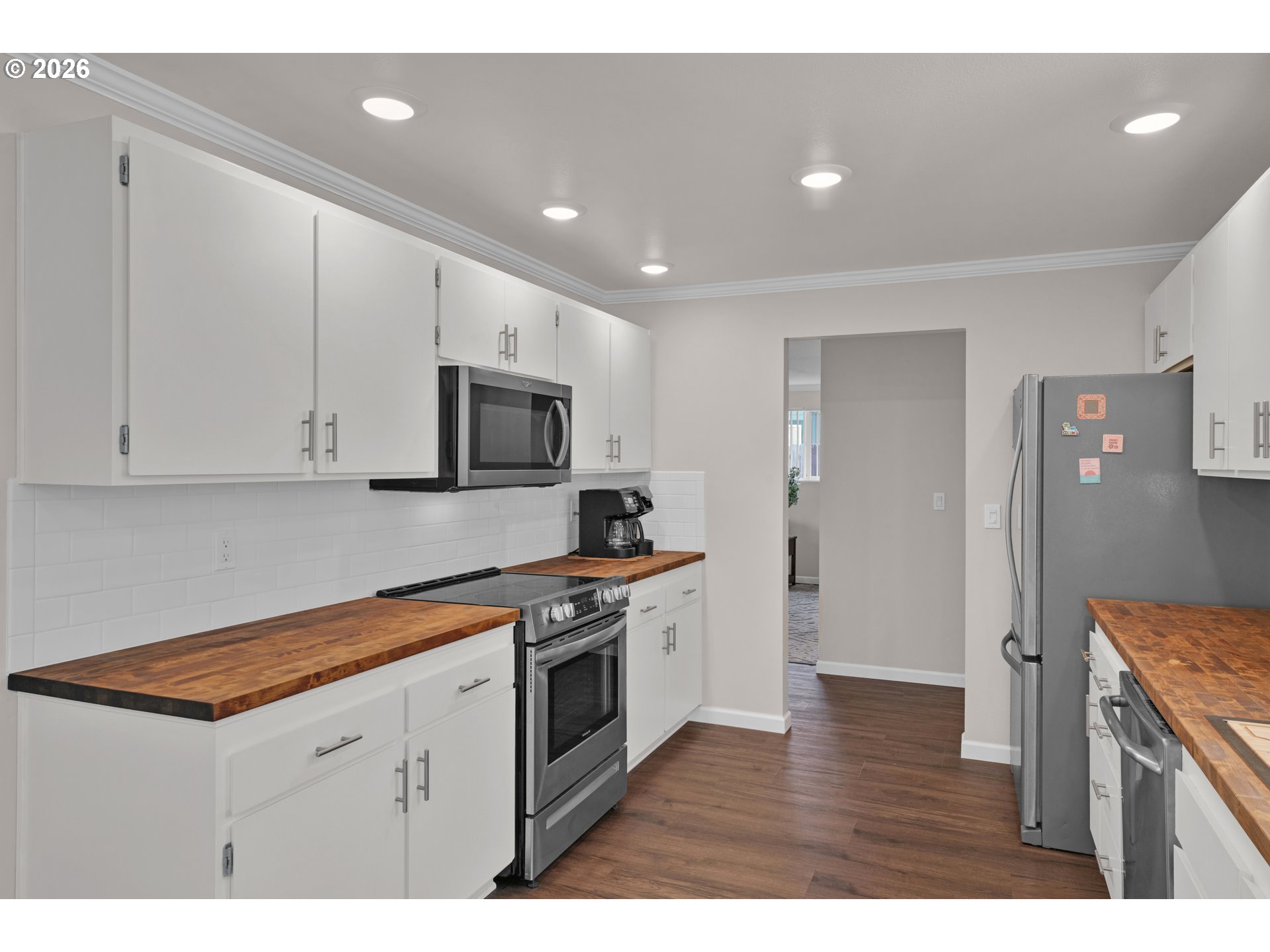 1142 9th Street Florence, OR 97439 - Photo 14 of 41 a kitchen with stainless steel appliances granite countertop a stove a sink and a refrigerator