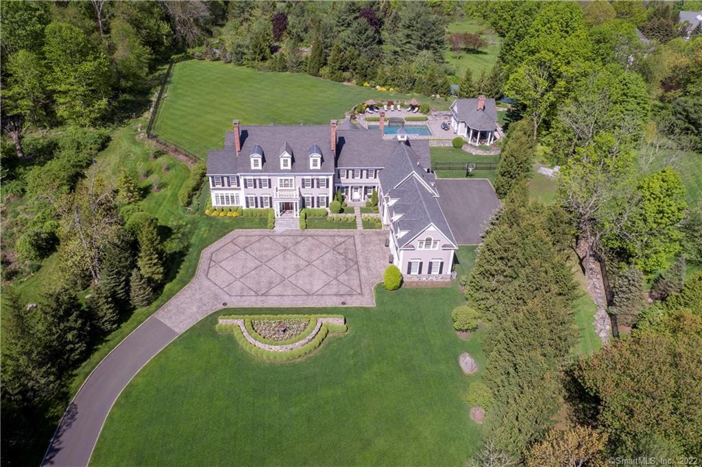an aerial view of a house with a garden and lake view