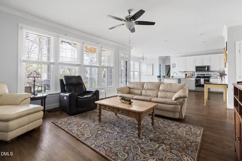 a kitchen with stainless steel appliances granite countertop a refrigerator a stove a sink dishwasher and a refrigerator with wooden floor