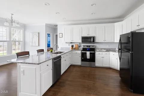 a kitchen with stainless steel appliances a refrigerator stove microwave and sink
