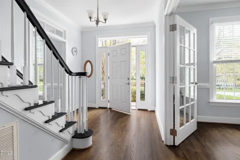 a view of an entryway with wooden floor and door