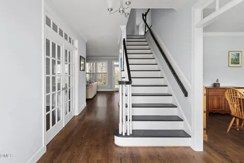a view of entryway with wooden floor and stairs