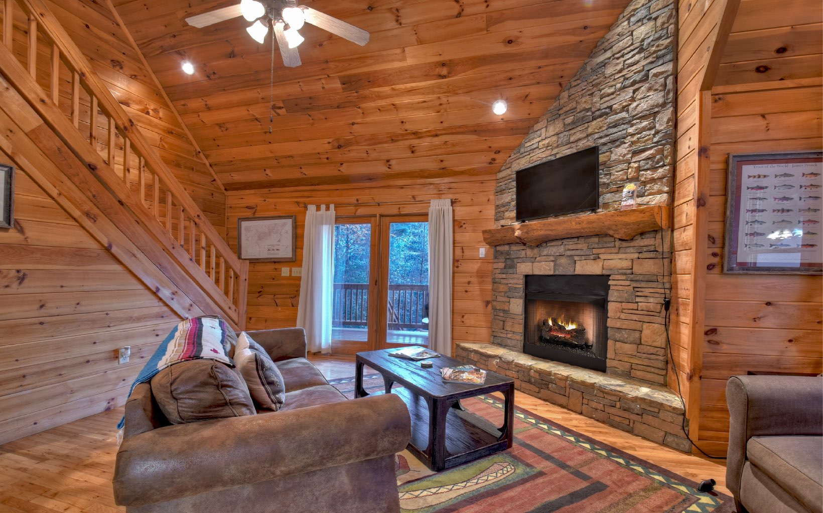 216 The Forest Road Blue Ridge, GA 30513 - Photo 22 of 41 a living room with furniture a flat screen tv and a fireplace