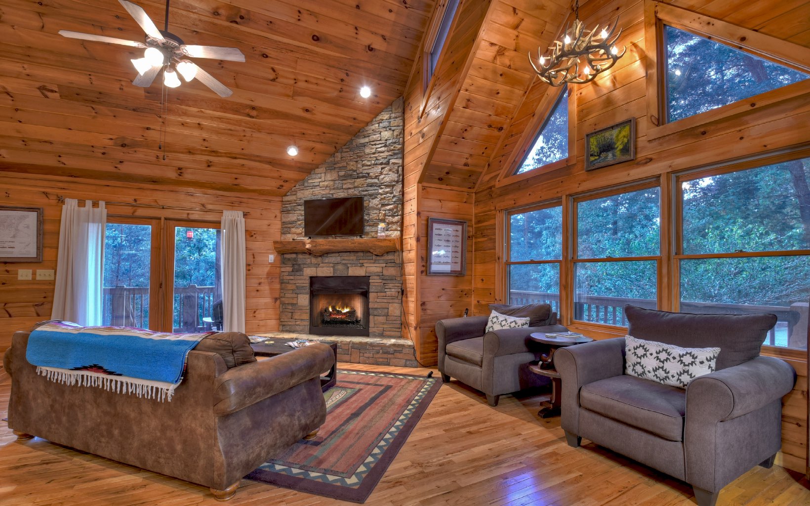 216 The Forest Road Blue Ridge, GA 30513 - Photo 23 of 41 a living room with furniture a fireplace and a flat screen tv
