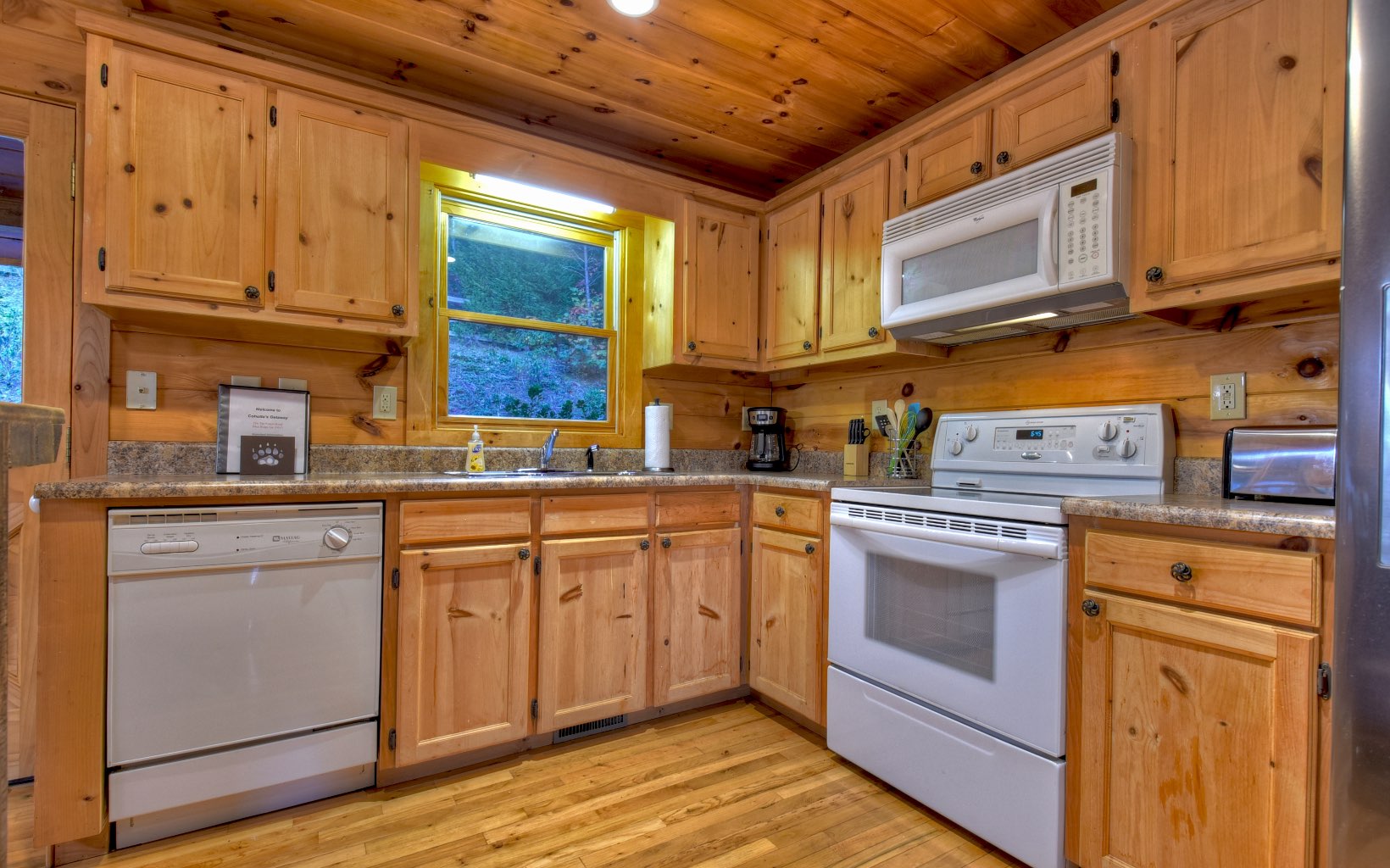 216 The Forest Road Blue Ridge, GA 30513 - Photo 25 of 41 a kitchen with granite countertop cabinets stainless steel appliances and a sink