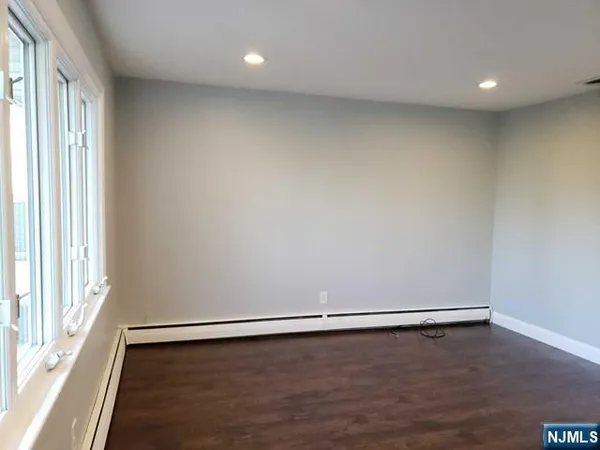 a view of a room with wooden floor and window