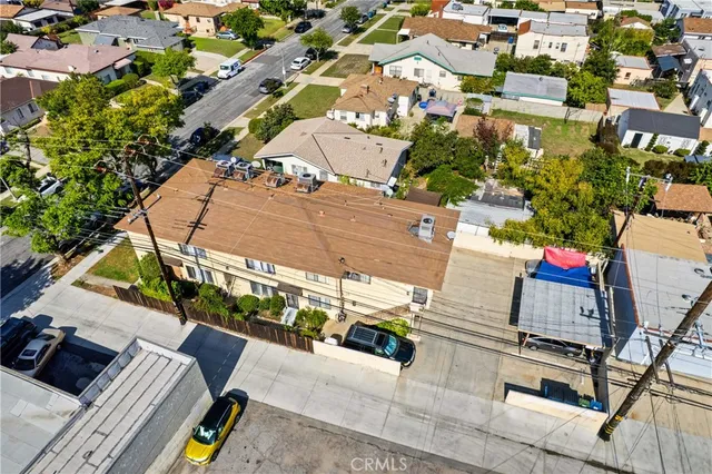 an aerial view of a houses with yard