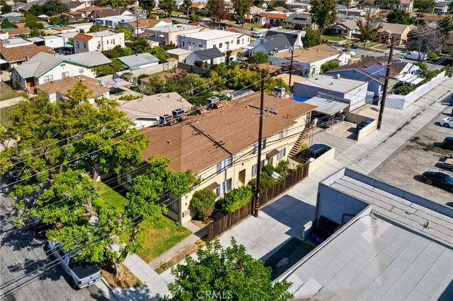 an aerial view of residential houses with yard
